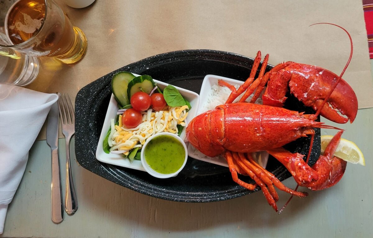 Fresh Mabou Lobster A whole steamed lobster served with salad and a beer